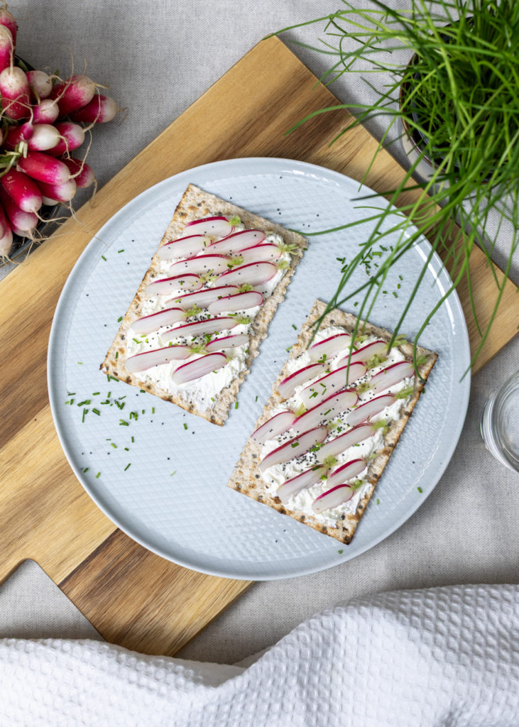 Tartines de pain azyme Heumann avec fromage frais, radis tranchés, herbes et graines